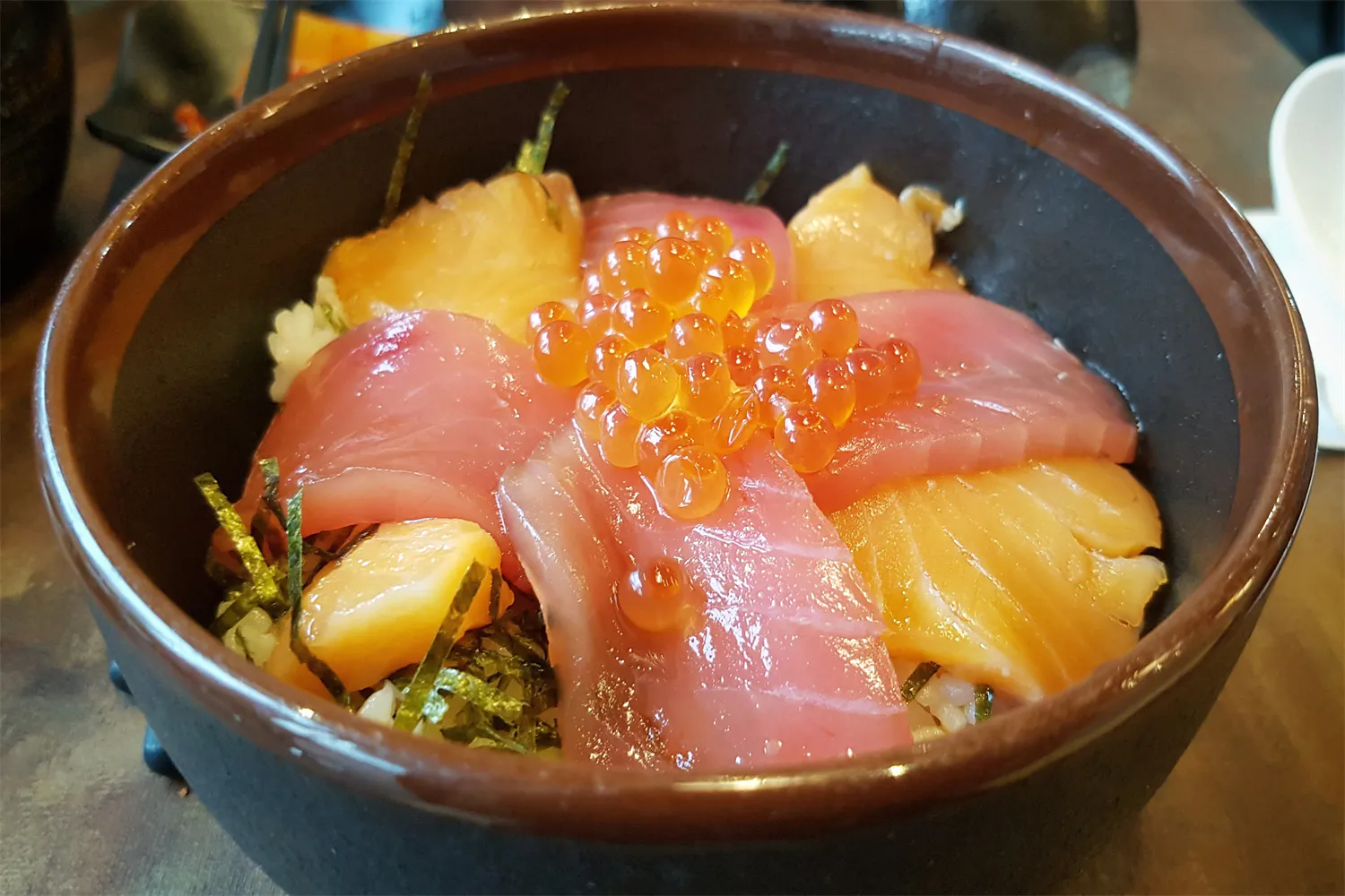 Seafood rice don bowl topped with fresh tuna, salmon and orange ikura roe at Cucumber Sushi, a Japanese Restaurant in Jersey City